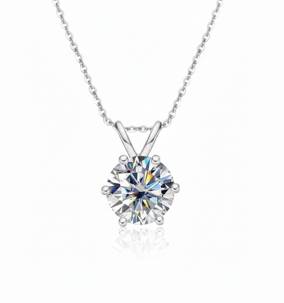 Diamond solitaire pendant necklace in white gold on pure white background