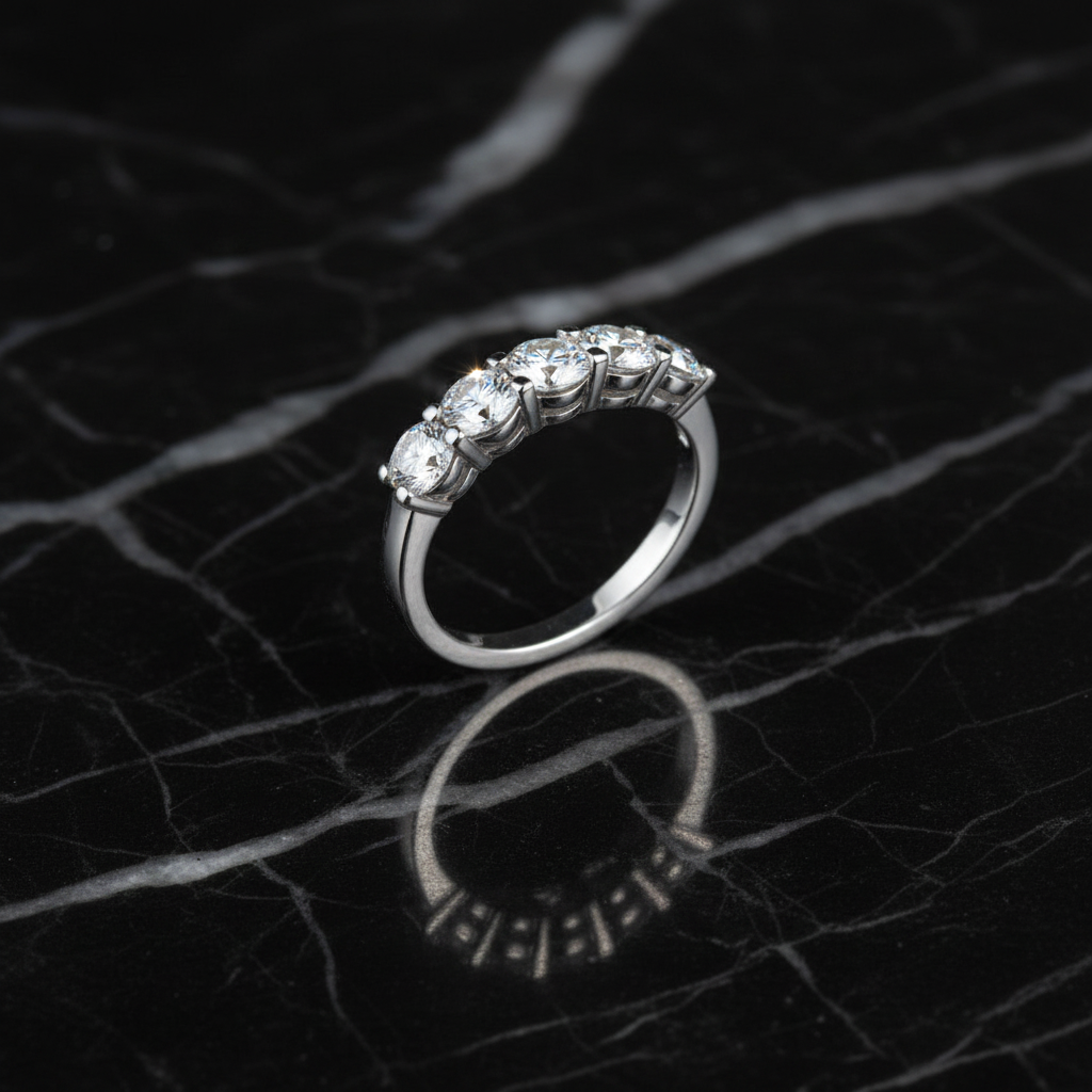 Five-stone diamond ring on black marble